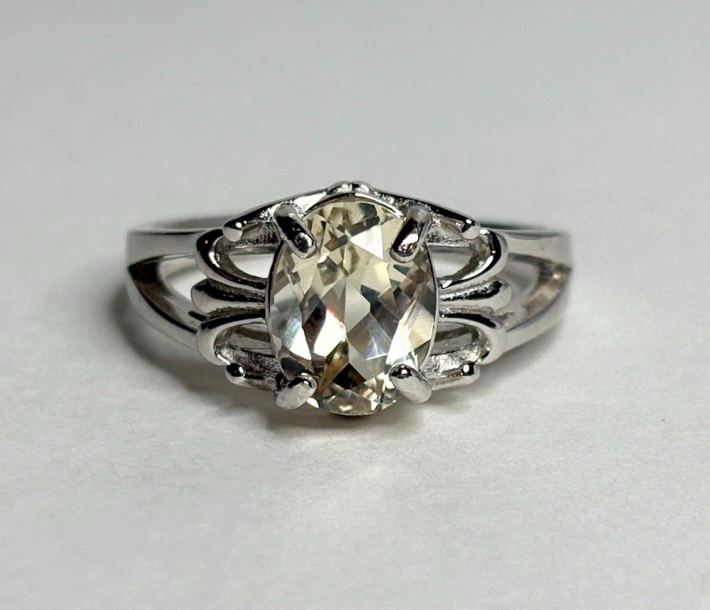 Yellow Oregon sunstone ring with fleur de lis design in sterling silver.