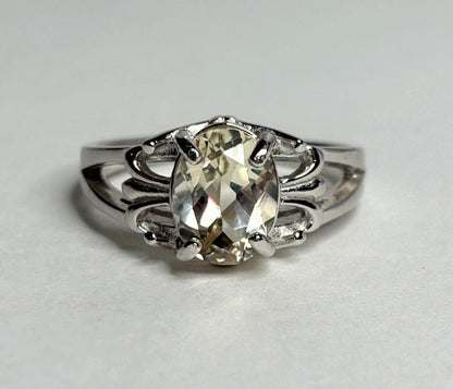 Yellow Oregon sunstone ring with fleur de lis design in sterling silver.