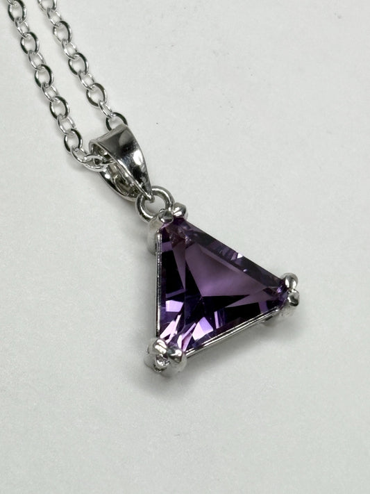 Sterling silver pendant necklace with a triangular amethyst gemstone.