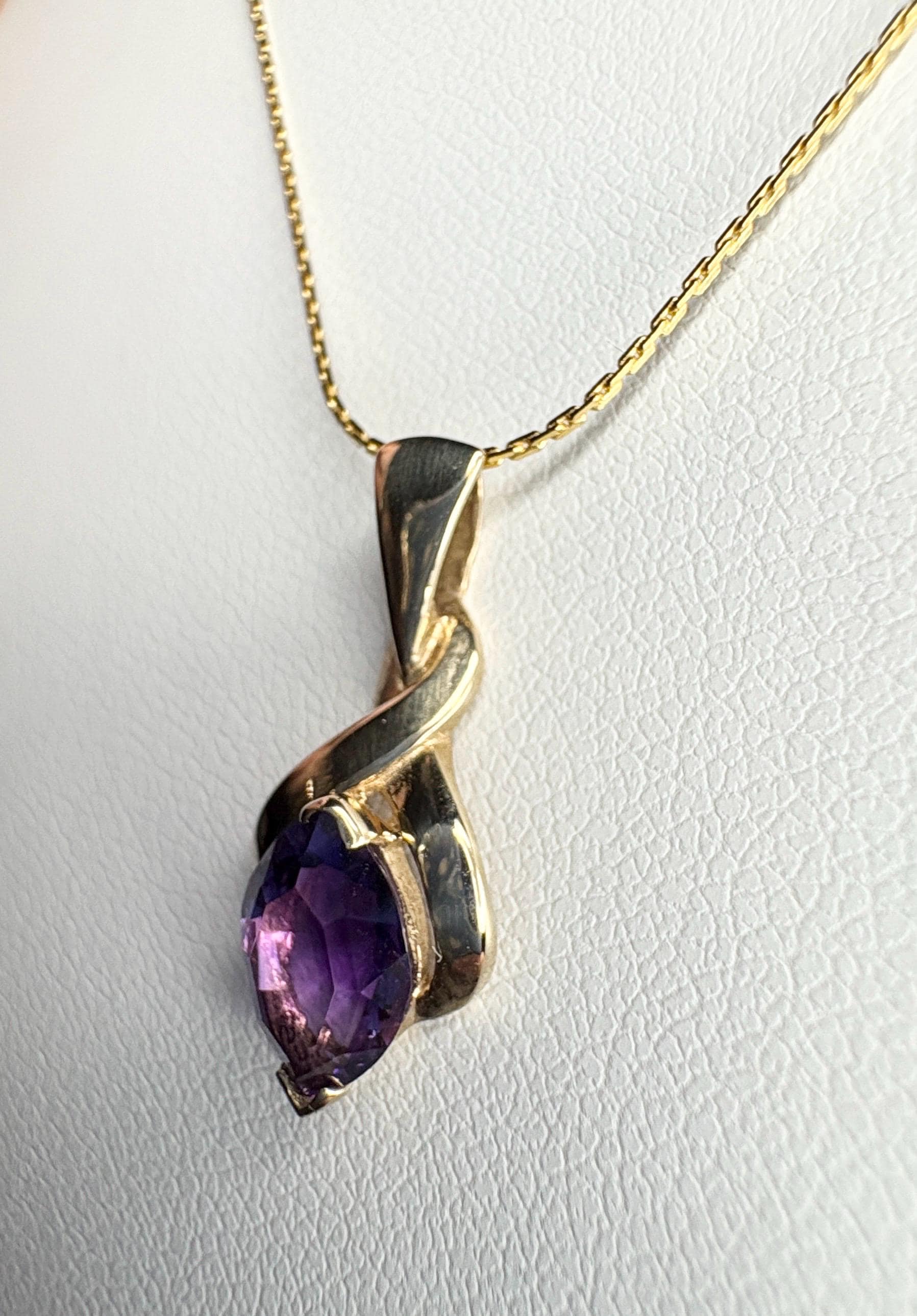 Vintage 9k gold pendant necklace with a marquise-cut amethyst.