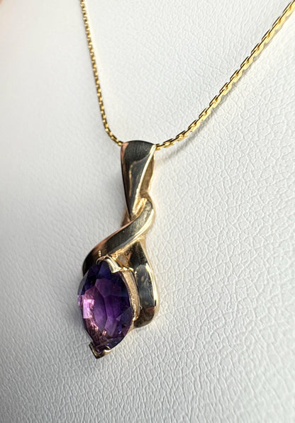 Vintage 9k gold pendant necklace with a marquise-cut amethyst.