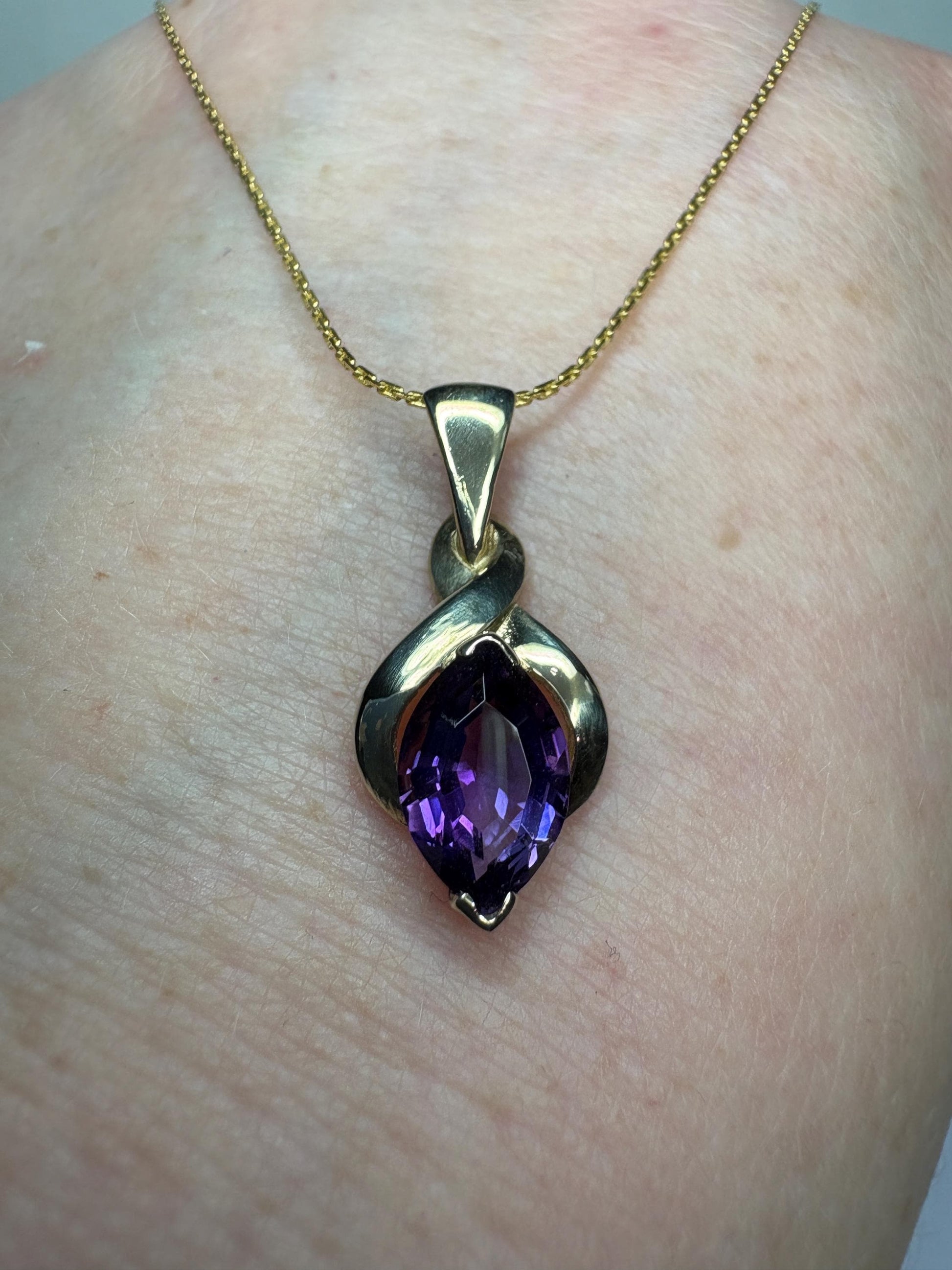 Vintage 9k gold pendant necklace with a marquise-cut amethyst.