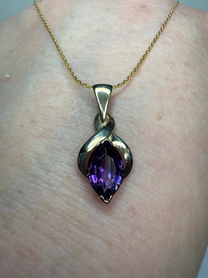 Vintage 9k gold pendant necklace with a marquise-cut amethyst.