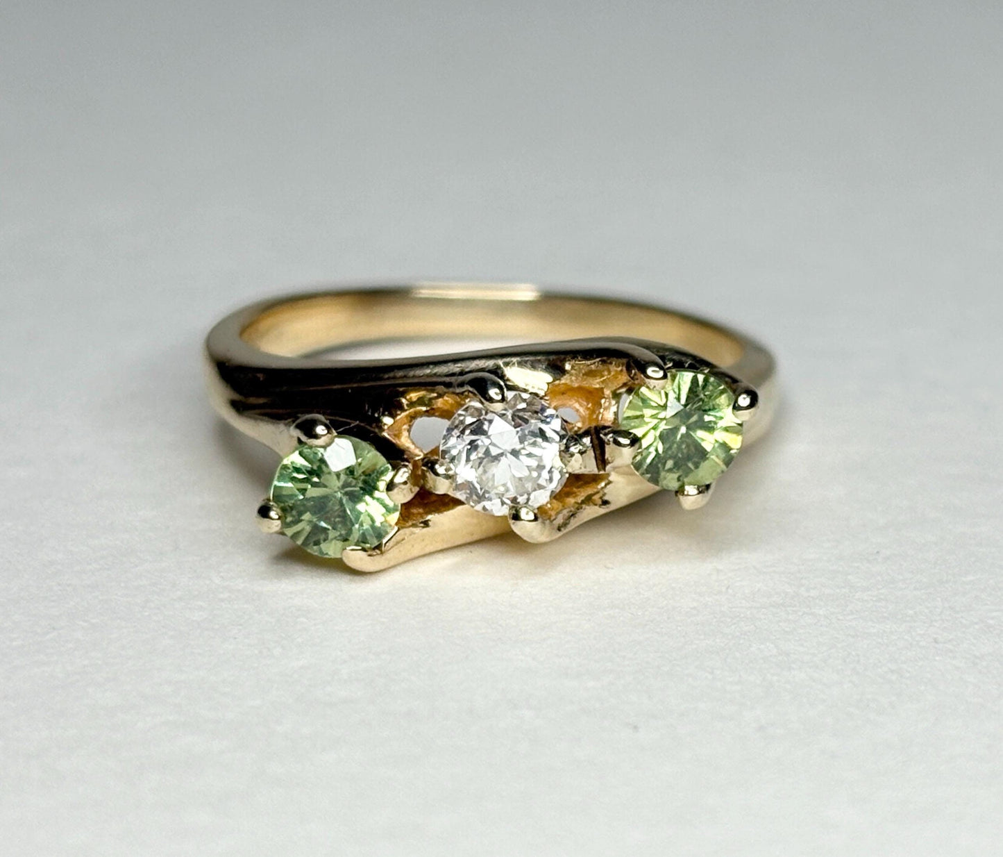 Vintage 10k gold ring with a diamond and two green demantoid garnets.