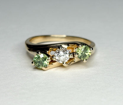Vintage 10k gold ring with a diamond and two green demantoid garnets.