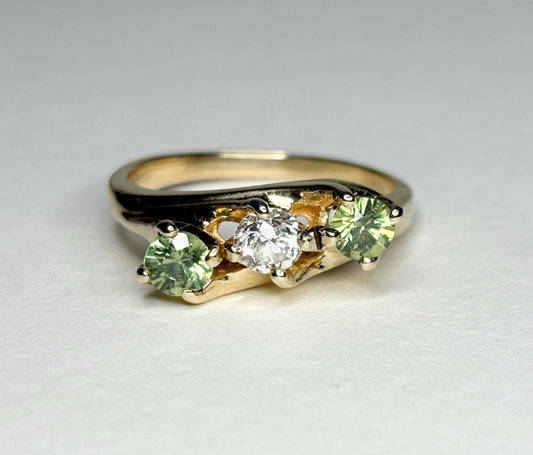 Vintage 10k gold ring with a diamond and two green demantoid garnets.