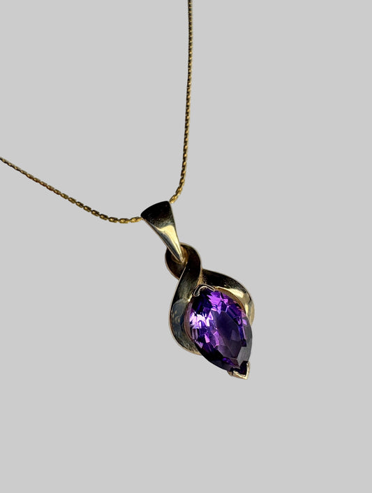 Vintage 9k gold pendant necklace with a marquise-cut amethyst.