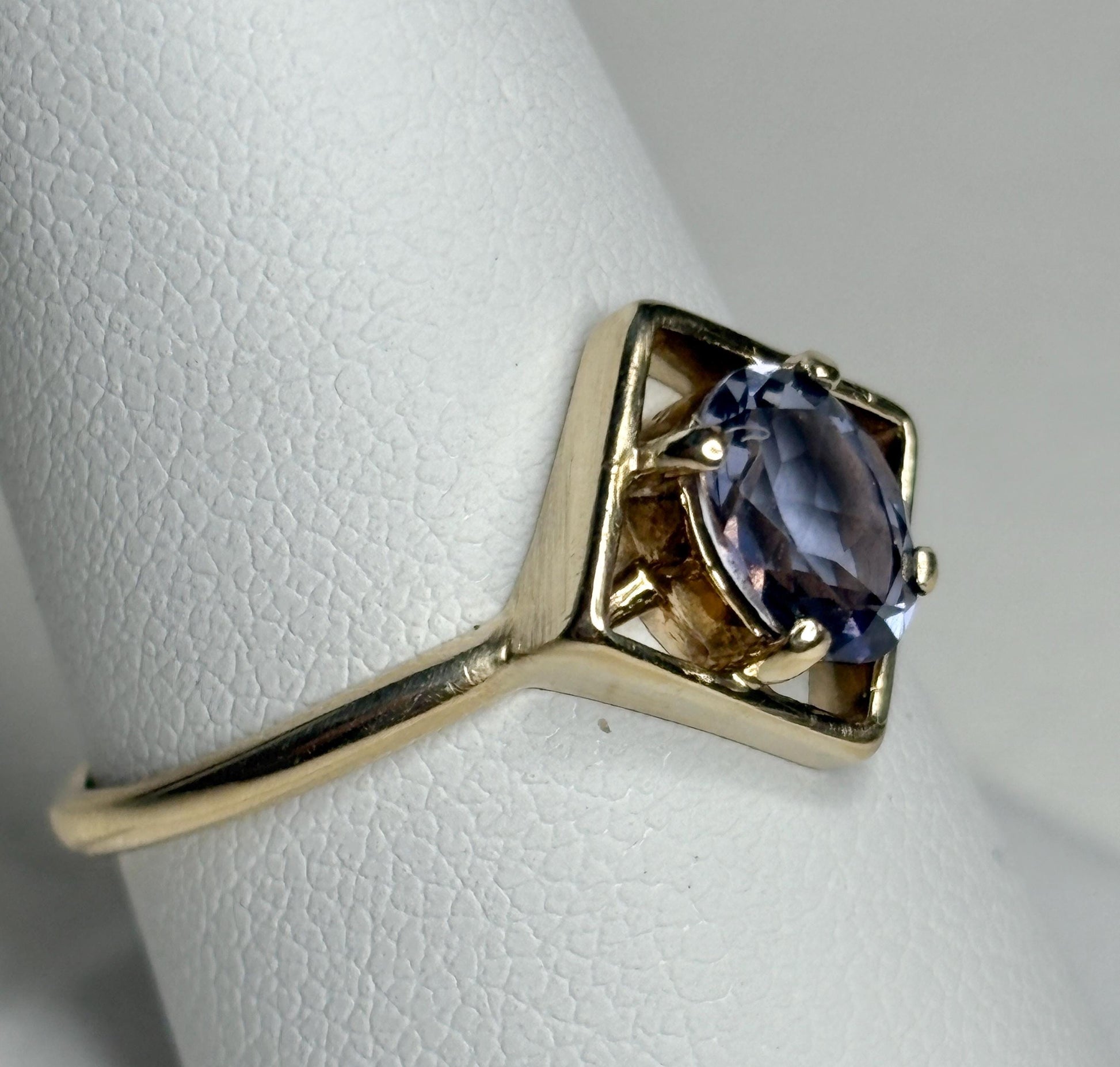 Geometric 10k gold ring with an oval iolite solitaire.