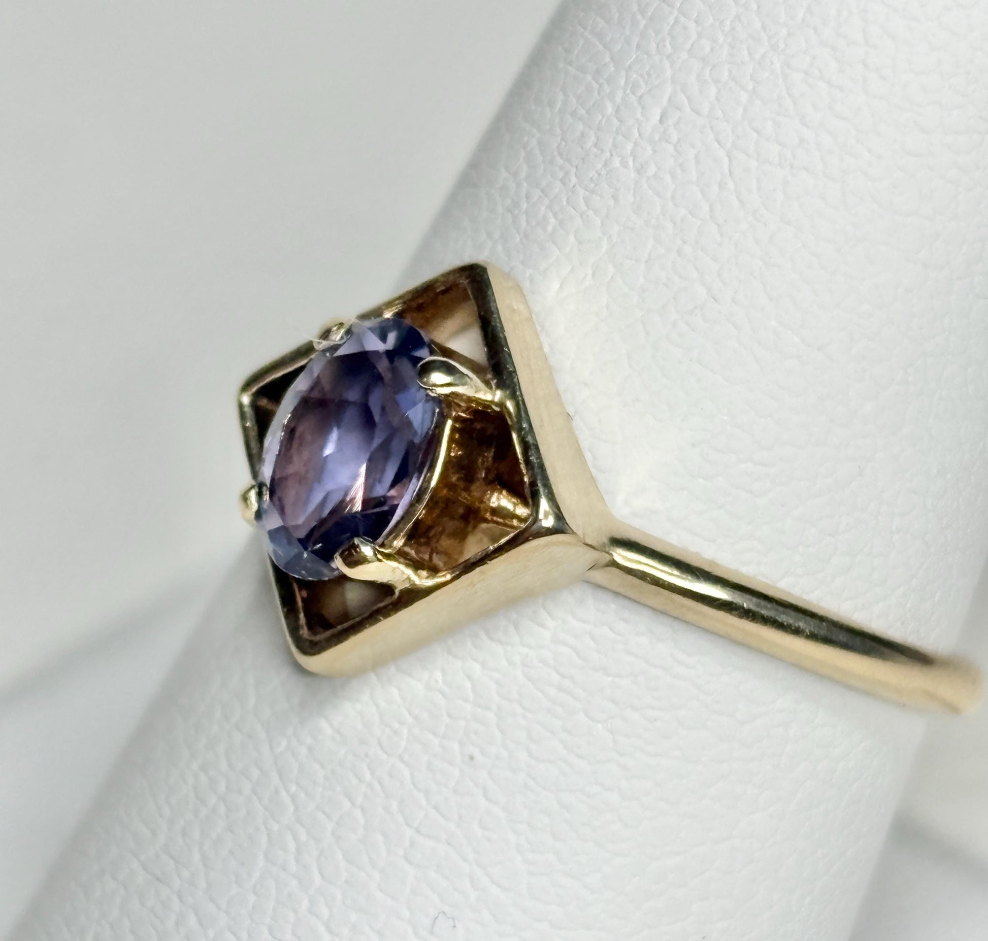 Geometric 10k gold ring with an oval iolite solitaire.