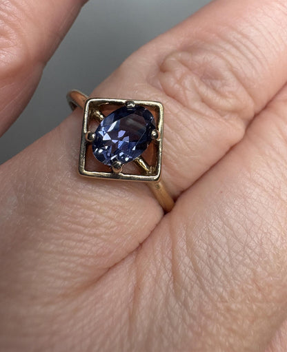 A geometric 10k gold ring with an oval iolite gemstone.