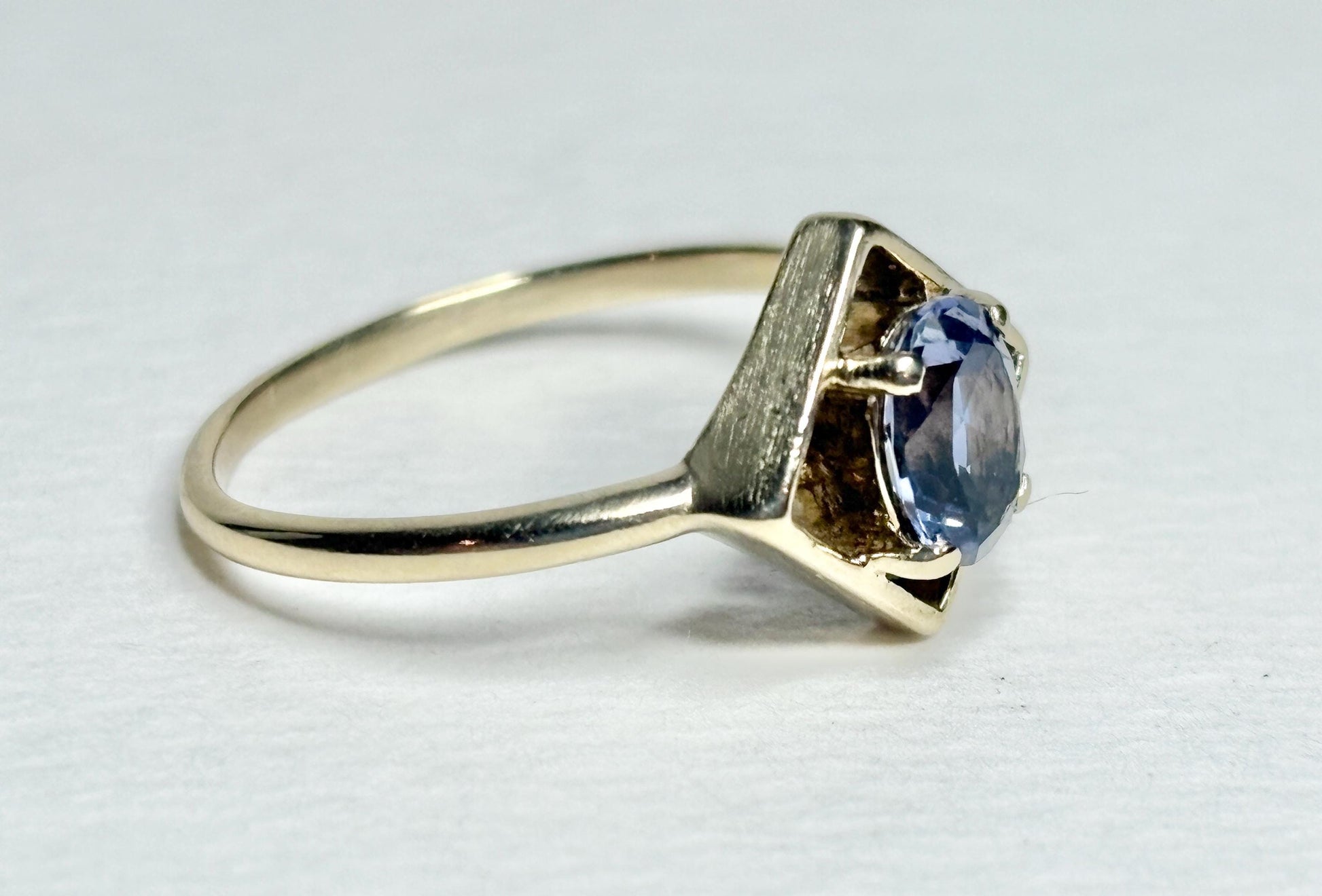 Geometric 10k gold ring with an oval iolite gemstone.