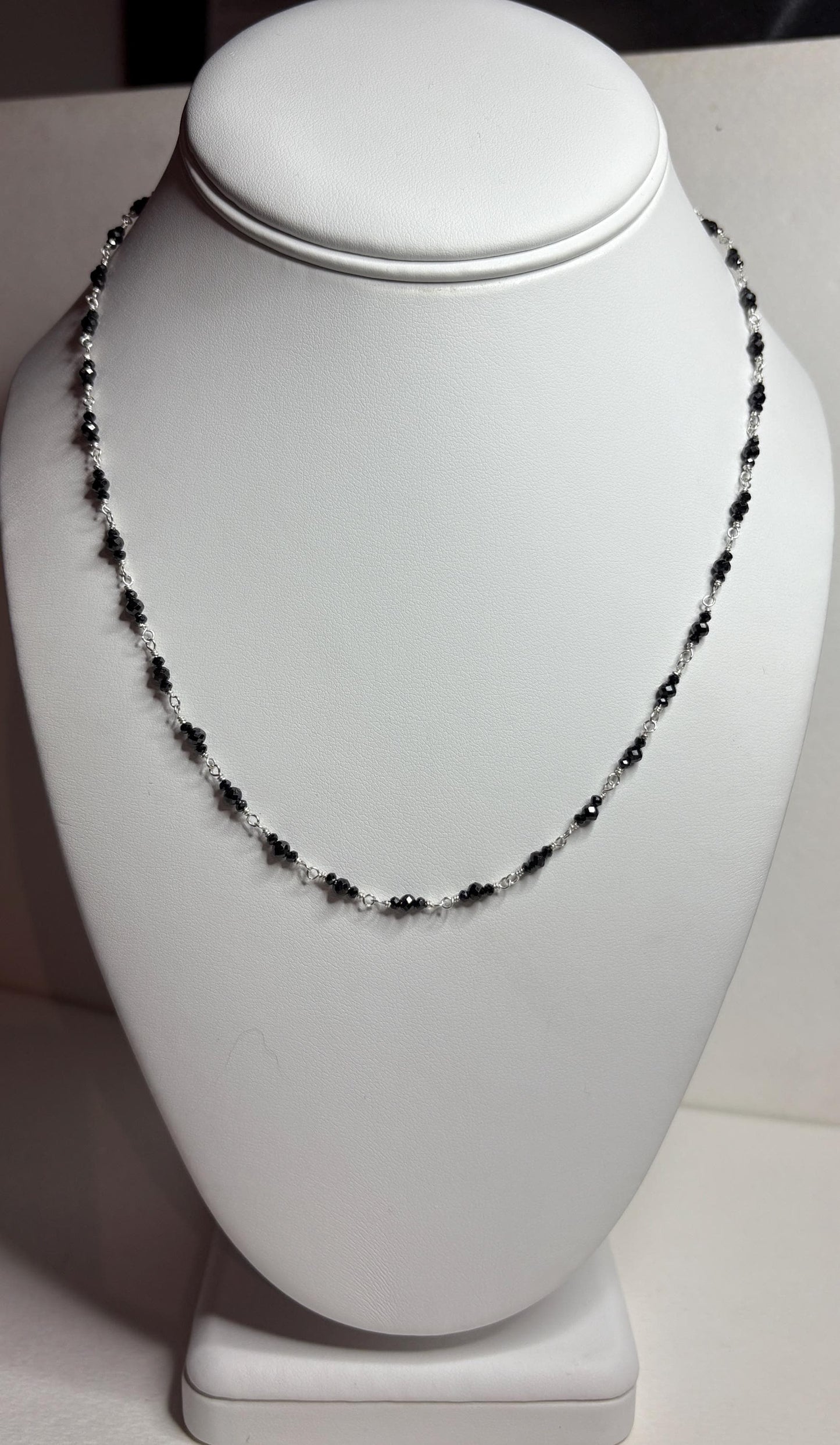 Sterling silver necklace with faceted black diamond beads.