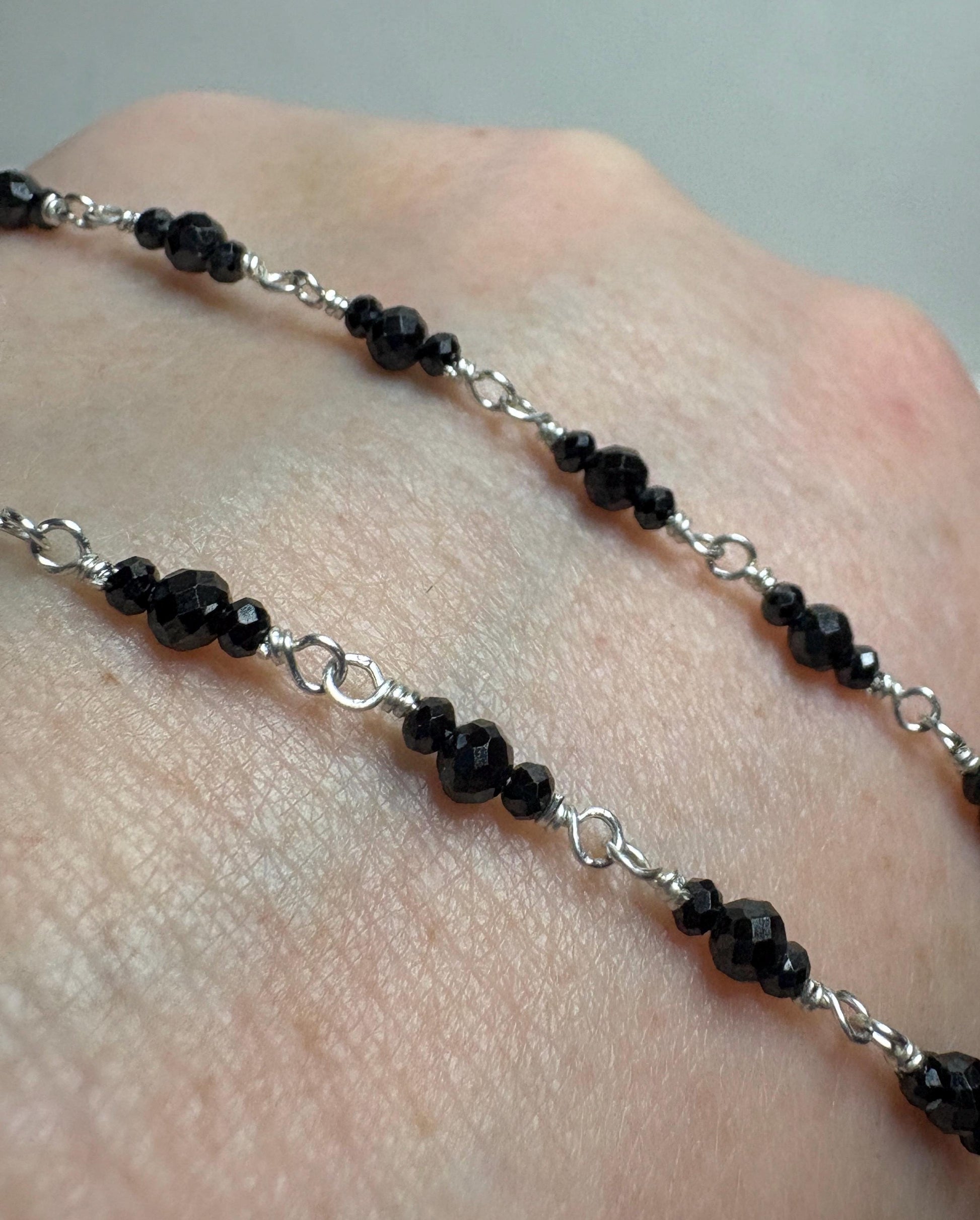 Sterling silver necklace with faceted black diamond beads.