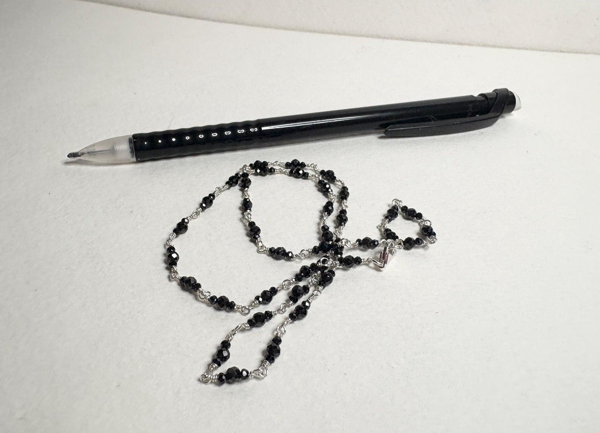 Sterling silver necklace with 2-3mm faceted black diamond beads.