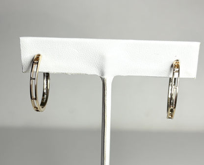 10k gold hoop earrings with channel-set brown diamonds.