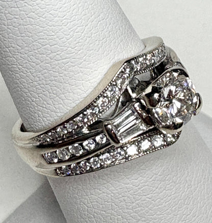 14k white gold ring with a central diamond and baguette and round accent diamonds.