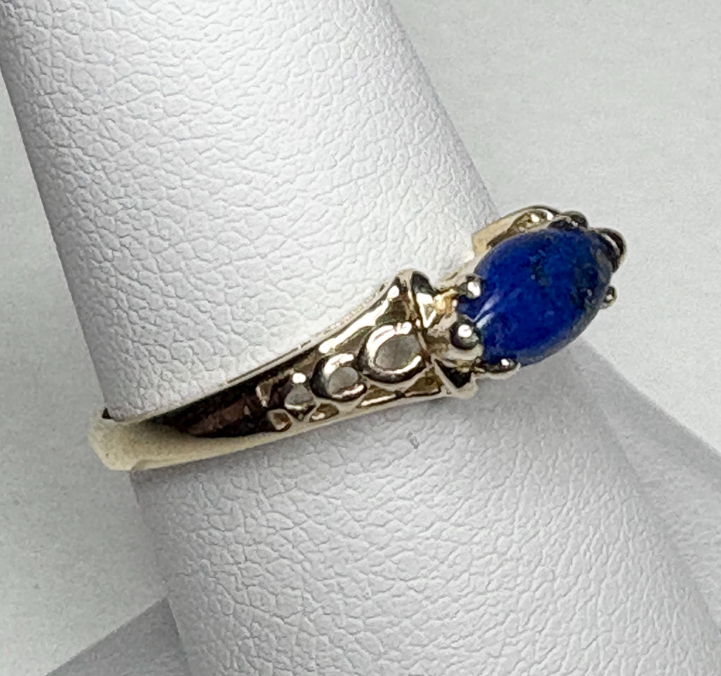 Lapis lazuli marquise cabochon set in solid 14k gold east west ring.