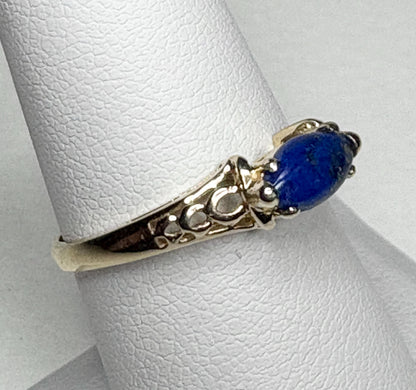 Lapis lazuli marquise cabochon set in solid 14k gold east west ring.