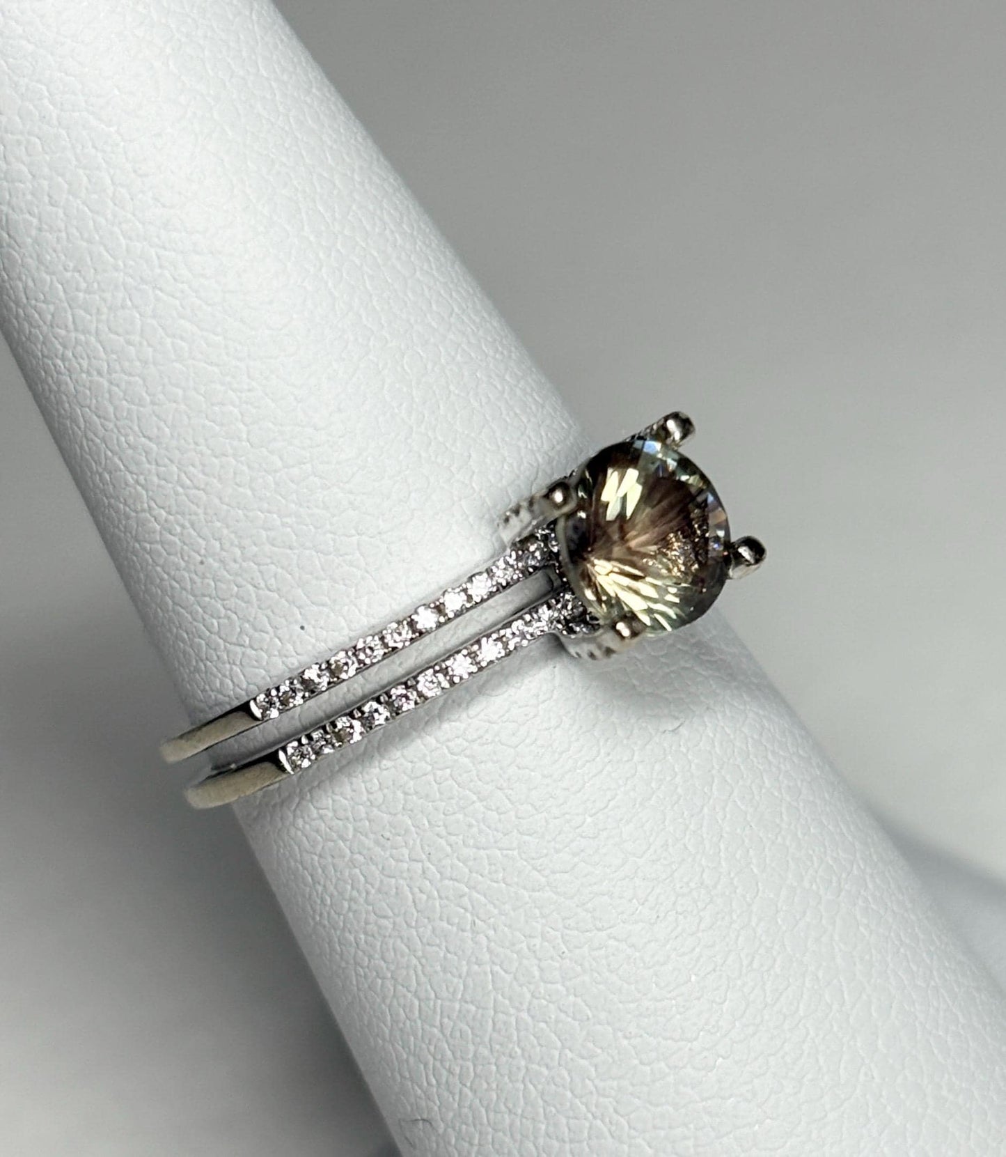 A bicolor Oregon sunstone ring with diamonds in white gold.