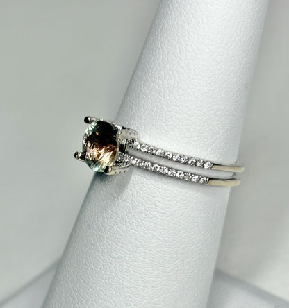 An oval bicolor Oregon sunstone ring with diamonds in 18k white gold.