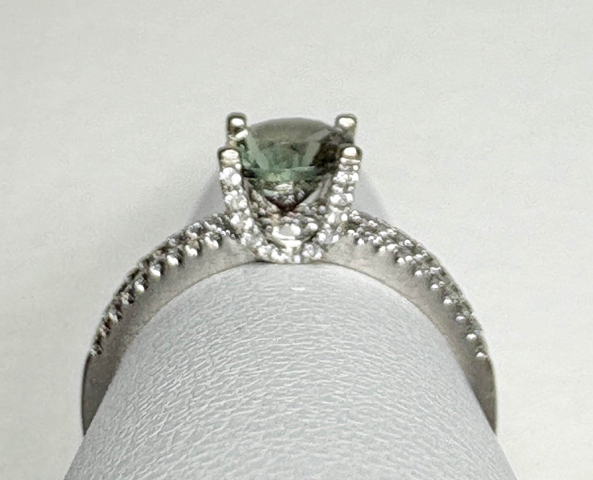 An 18k white gold ring with a bicolor Oregon sunstone and .20ctw diamonds.