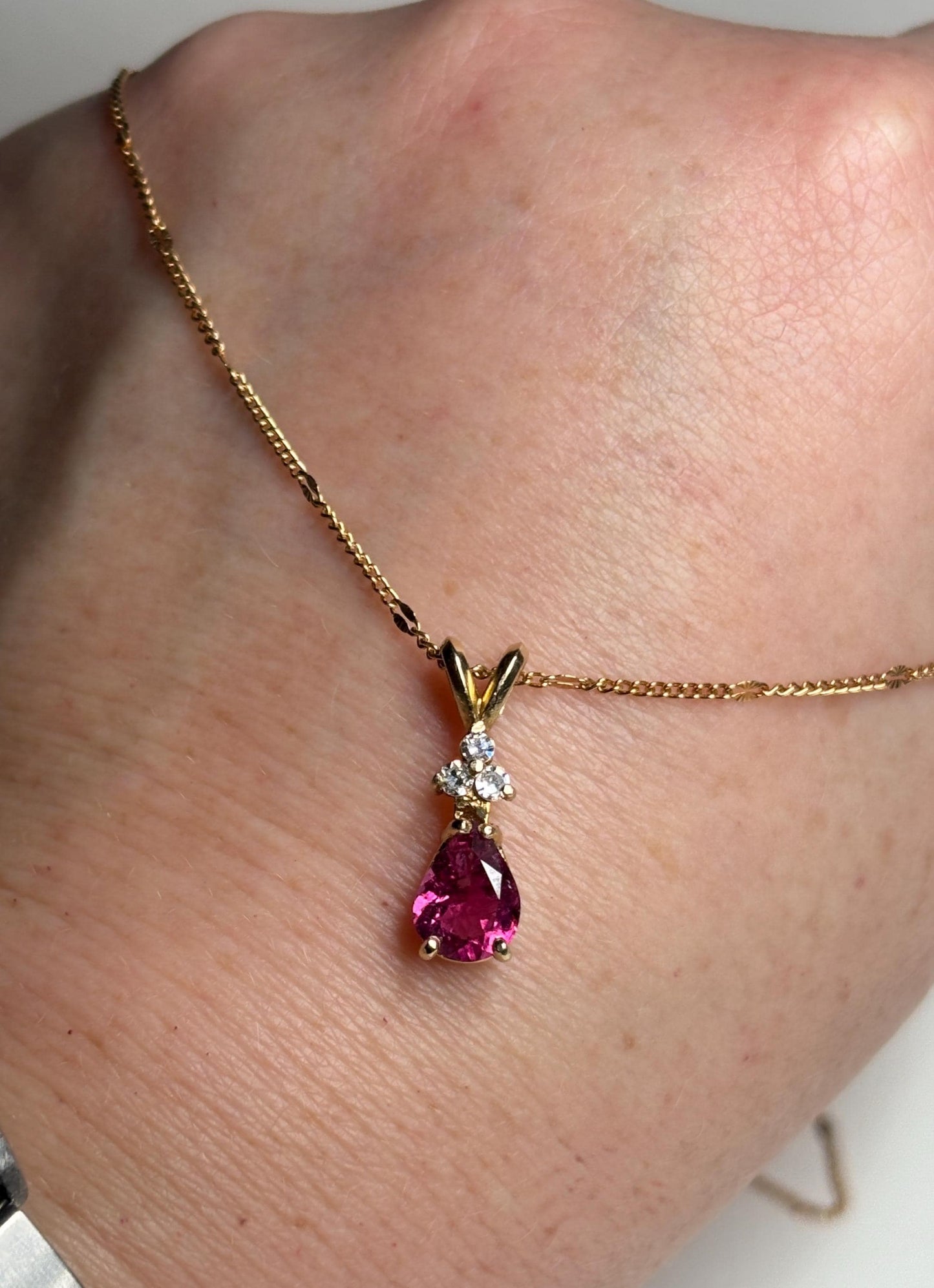14k gold necklace with a pear-shaped rubellite tourmaline and diamond pendant.