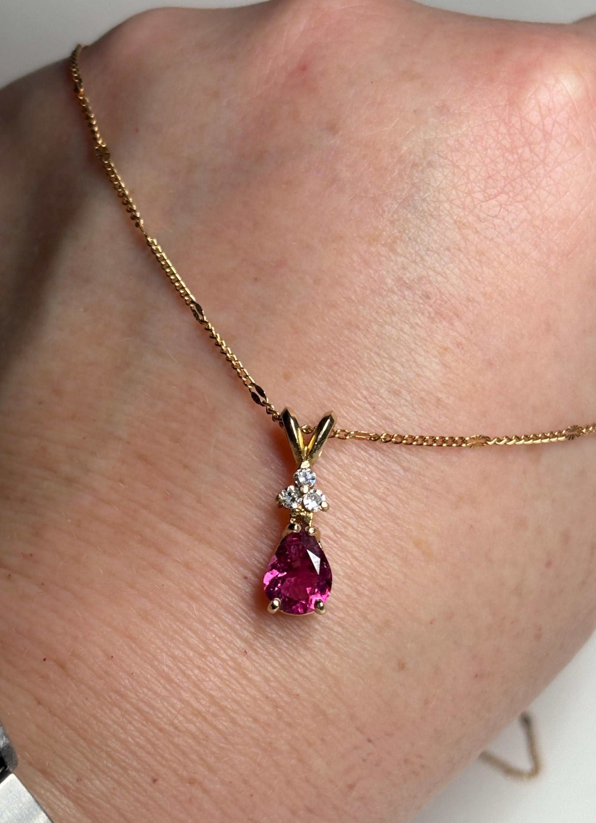 14k gold necklace with a pear-shaped rubellite tourmaline and diamond pendant.