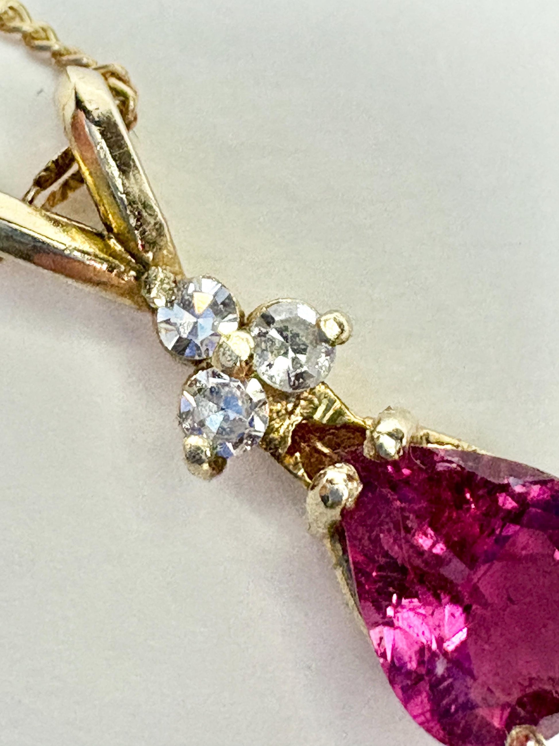 Rubellite tourmaline and diamond pendant on a 14k gold necklace.