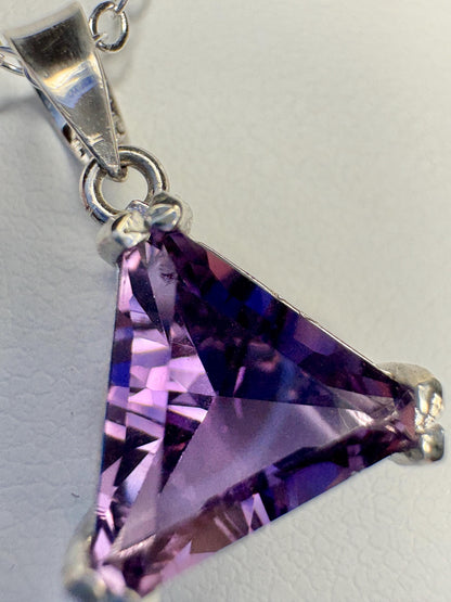 Sterling silver pendant with a triangular cut amethyst gemstone.