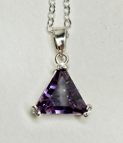 Sterling silver pendant necklace with a triangular amethyst gemstone.