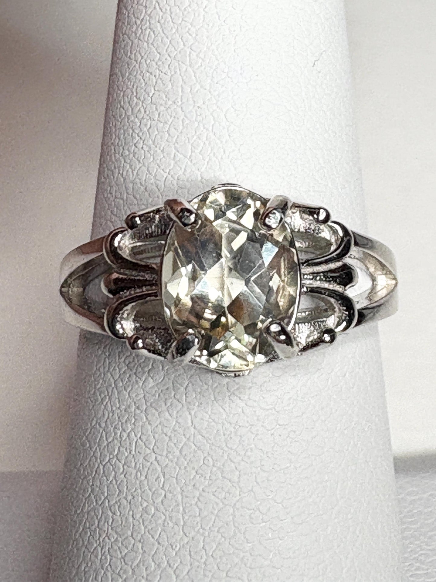 Sterling silver ring with an oval yellow Oregon sunstone and fleur de lis accents.
