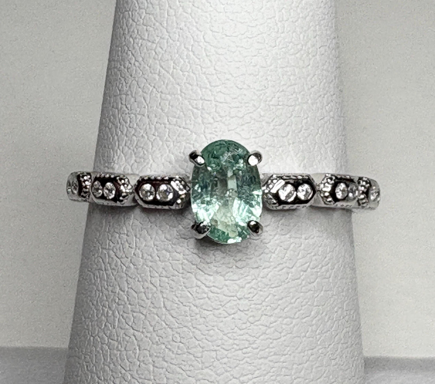 Sterling silver ring with an oval mint green tourmaline and small crystal accents.