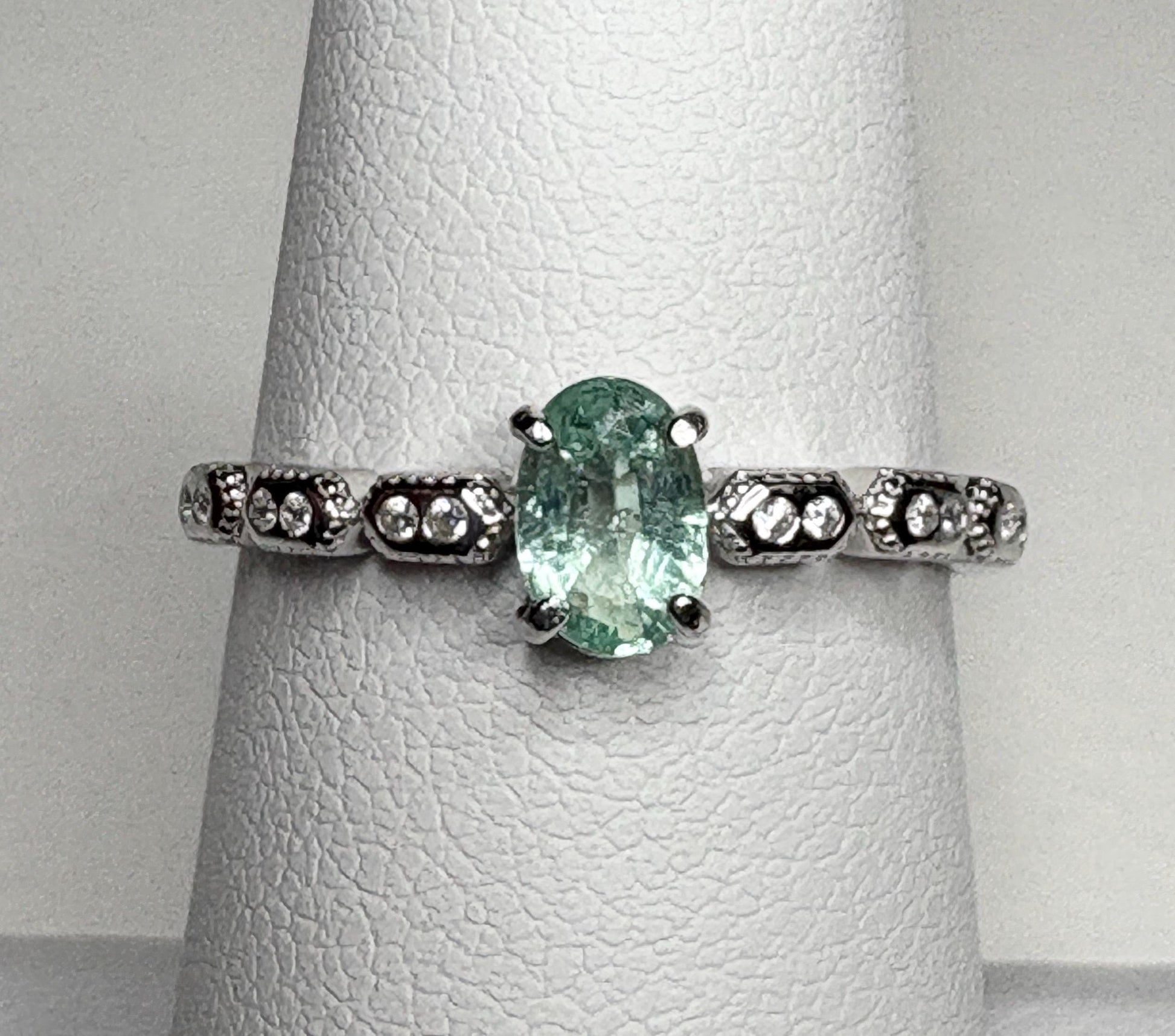 Sterling silver ring with an oval mint green tourmaline and small crystal accents.