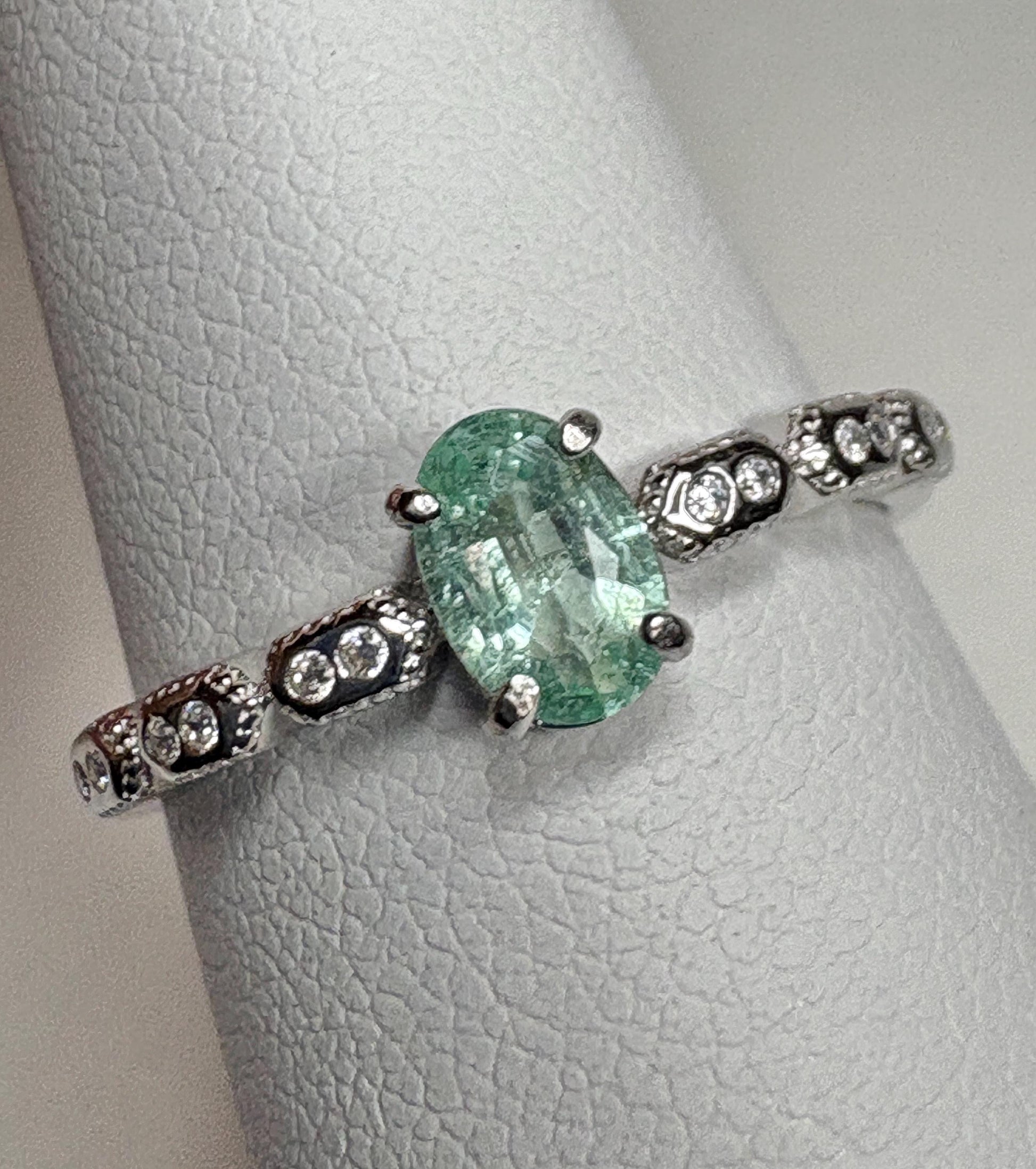 Sterling silver ring with an oval mint green tourmaline and small crystal accents.