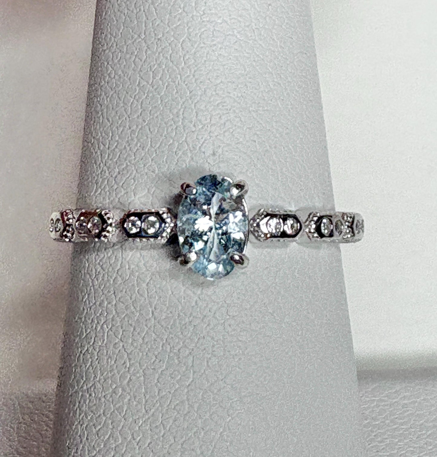 Sterling silver ring with oval light blue tourmaline and crystal accents.