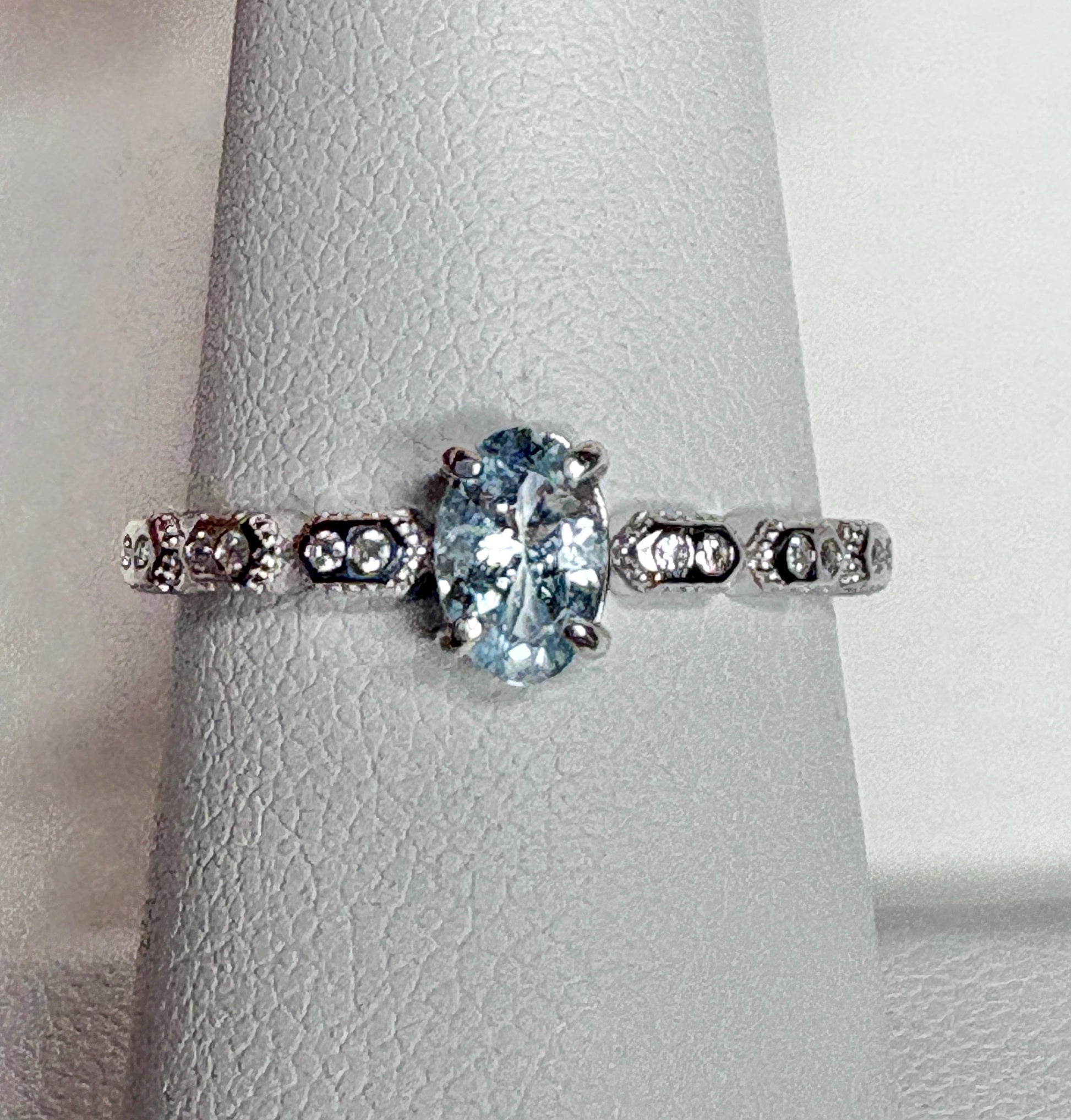 Sterling silver ring with oval light blue tourmaline and crystal accents.