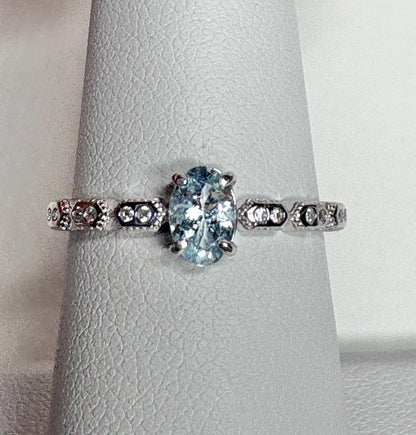 Sterling silver ring with oval light blue tourmaline and crystal accents.