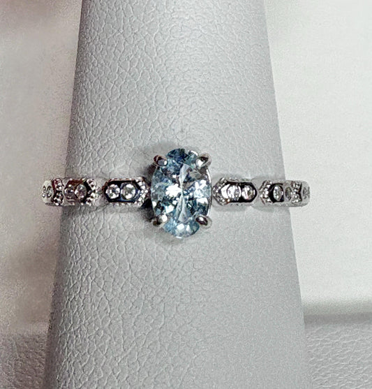 Sterling silver ring with oval light blue tourmaline and crystal accents.