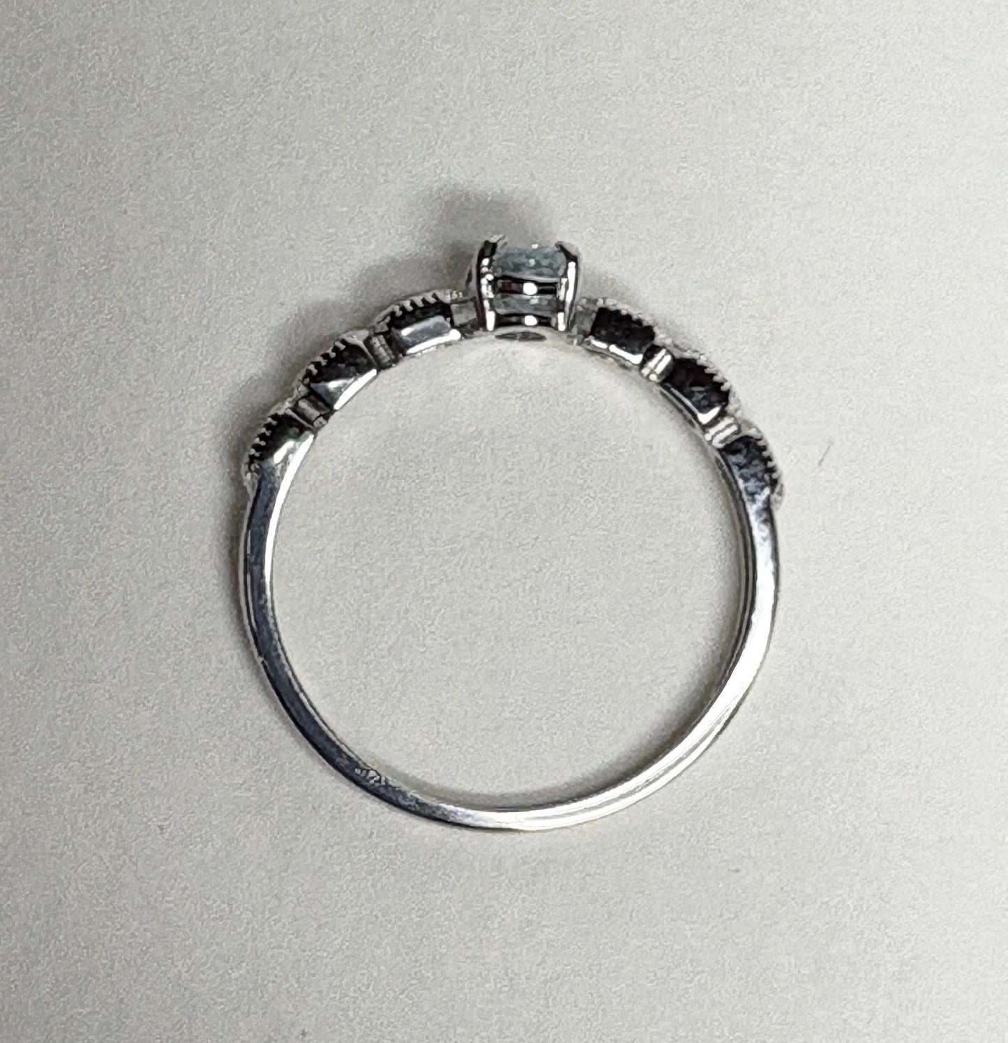 Sterling silver ring with a light blue oval tourmaline and crystal accents.