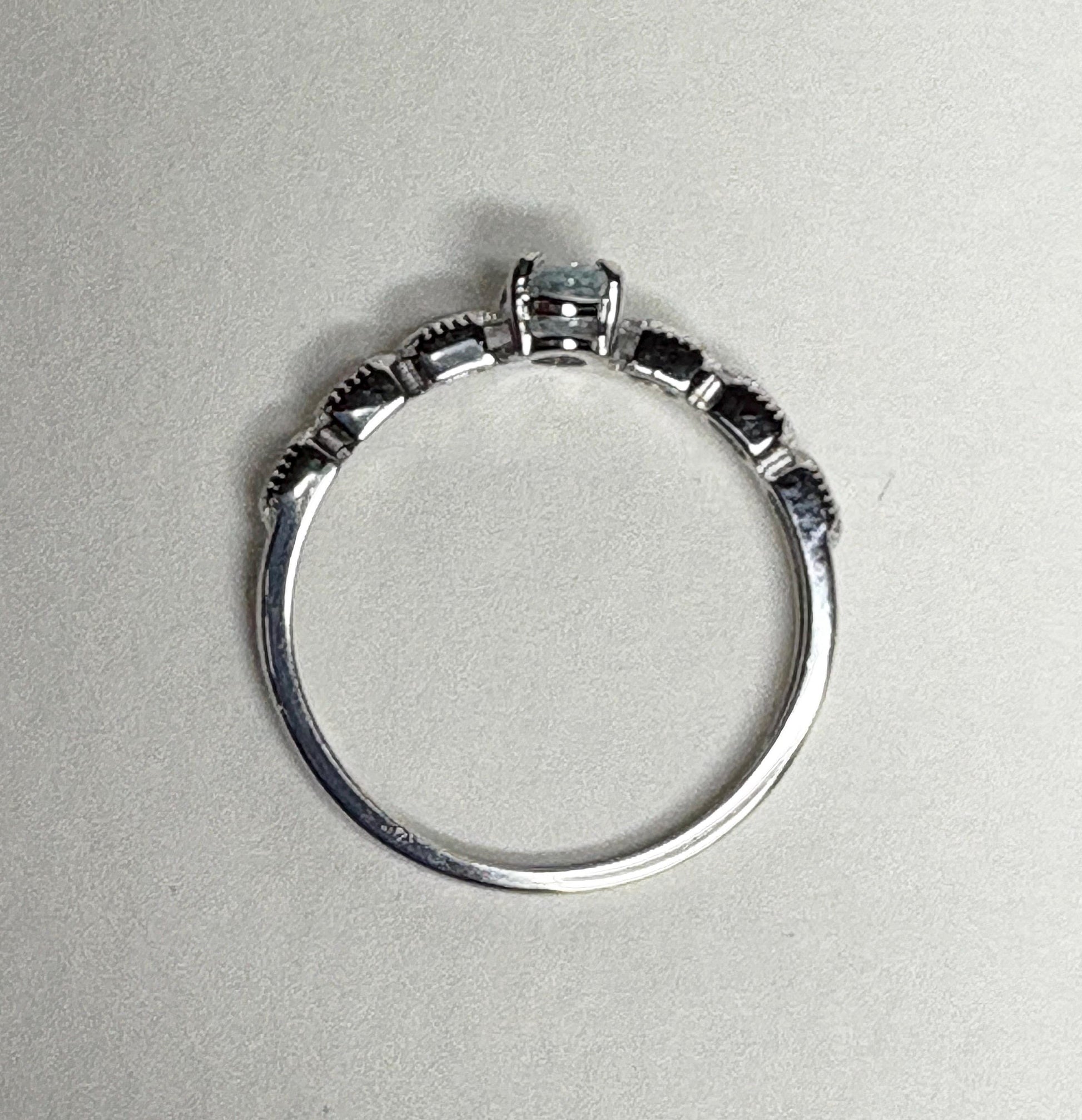 Sterling silver ring with a light blue oval tourmaline and crystal accents.