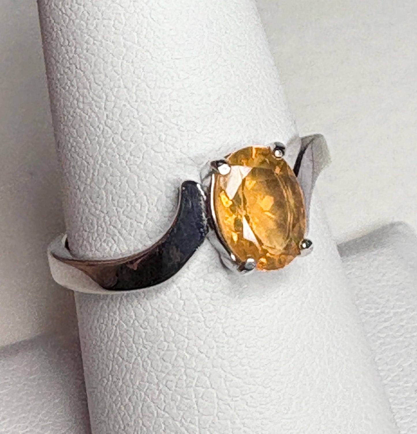 Sterling silver bypass ring with an oval Brazilian fire opal.