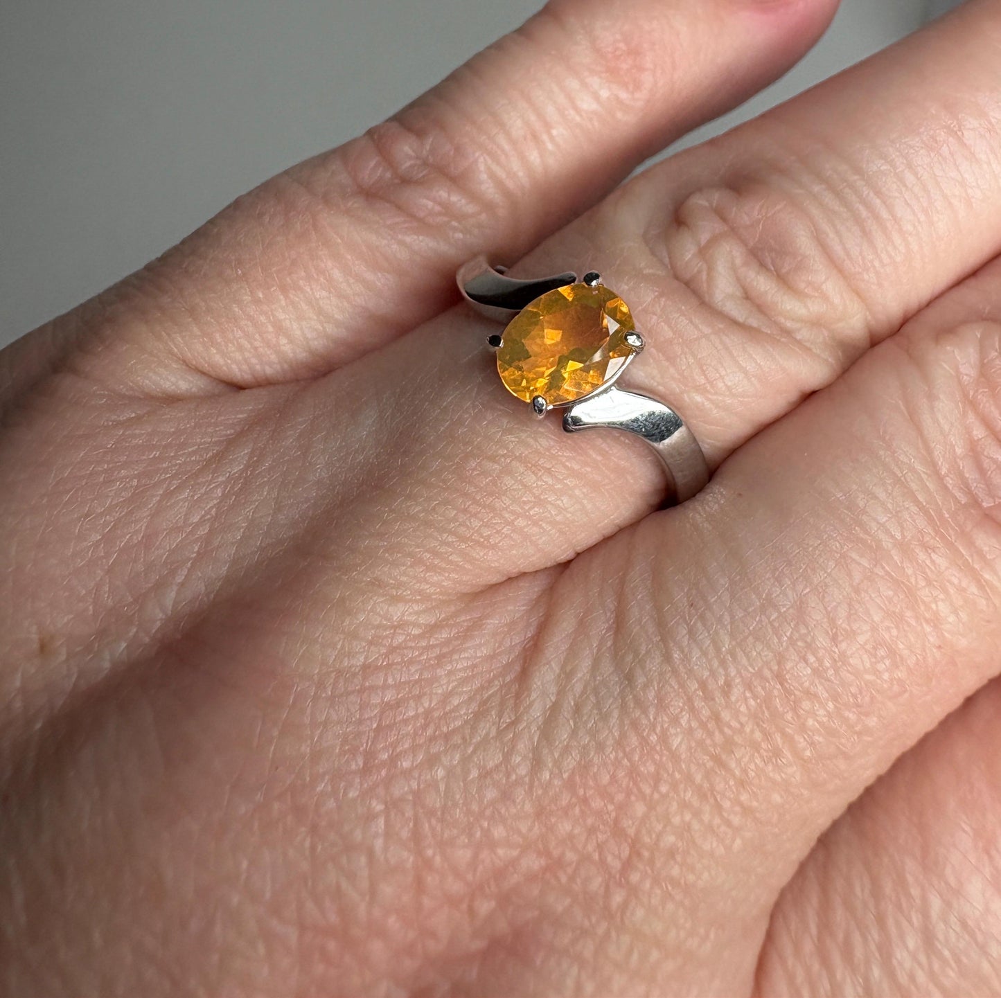 Sterling silver bypass ring with an oval Brazilian fire opal.