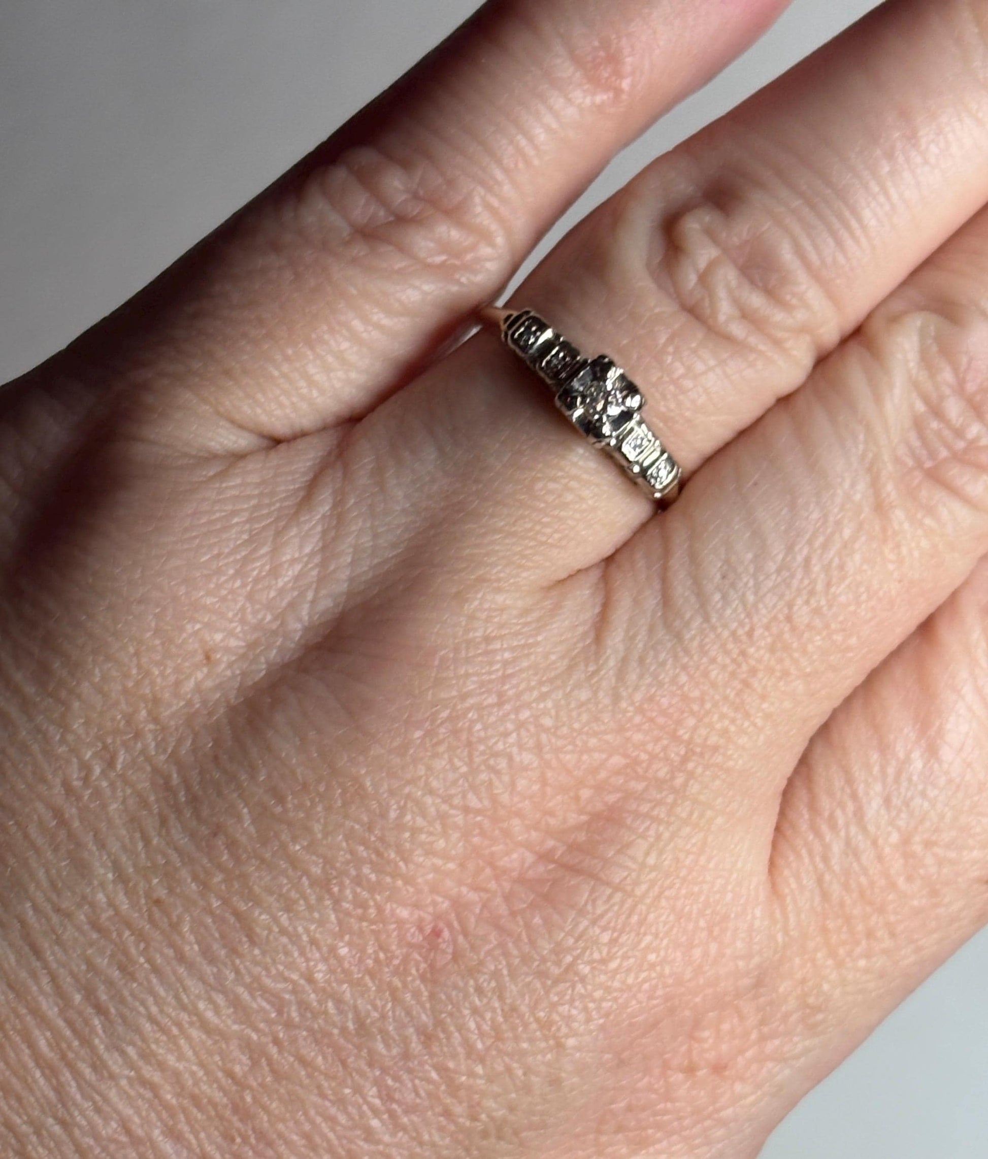 Vintage 14k gold two-tone engagement ring with small diamonds.