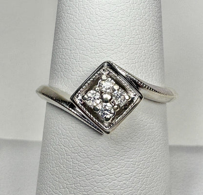 Natural diamond cluster ring in a square setting on a white gold band.