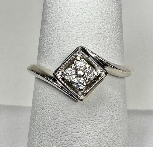 Natural diamond cluster ring in a square setting on a white gold band.