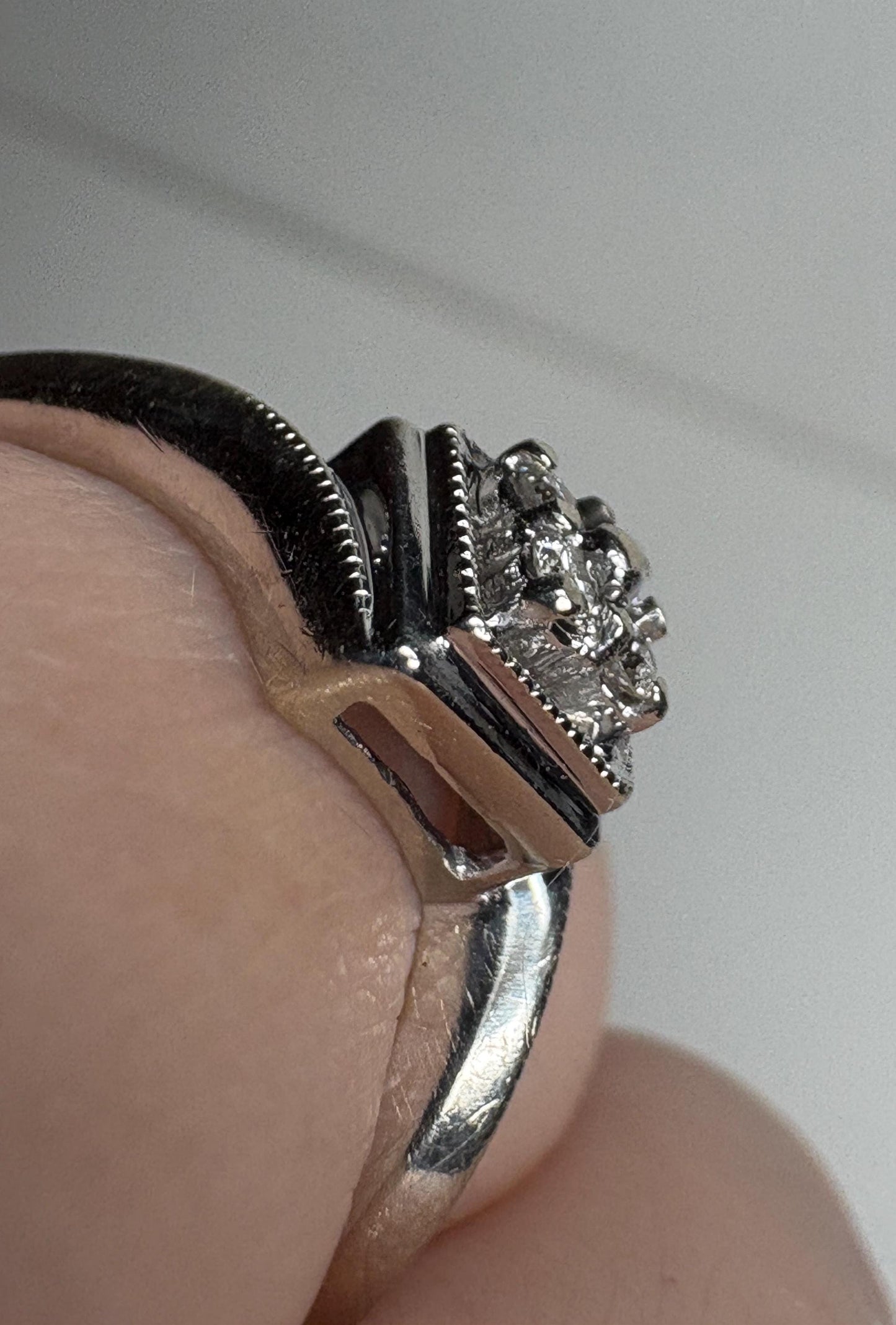 10k white gold ring with a square cluster of natural diamonds and milgrain detailing.