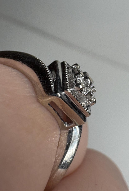 10k white gold ring with a square cluster of natural diamonds and milgrain detailing.