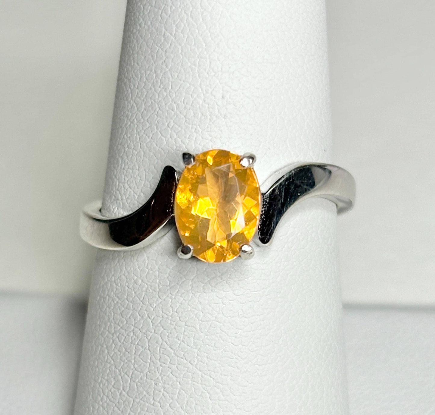 Sterling silver bypass ring with an oval Brazilian fire opal.