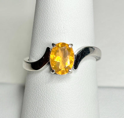 Sterling silver bypass ring with an oval Brazilian fire opal.