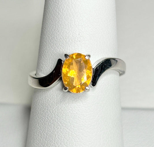 Sterling silver bypass ring with an oval Brazilian fire opal.